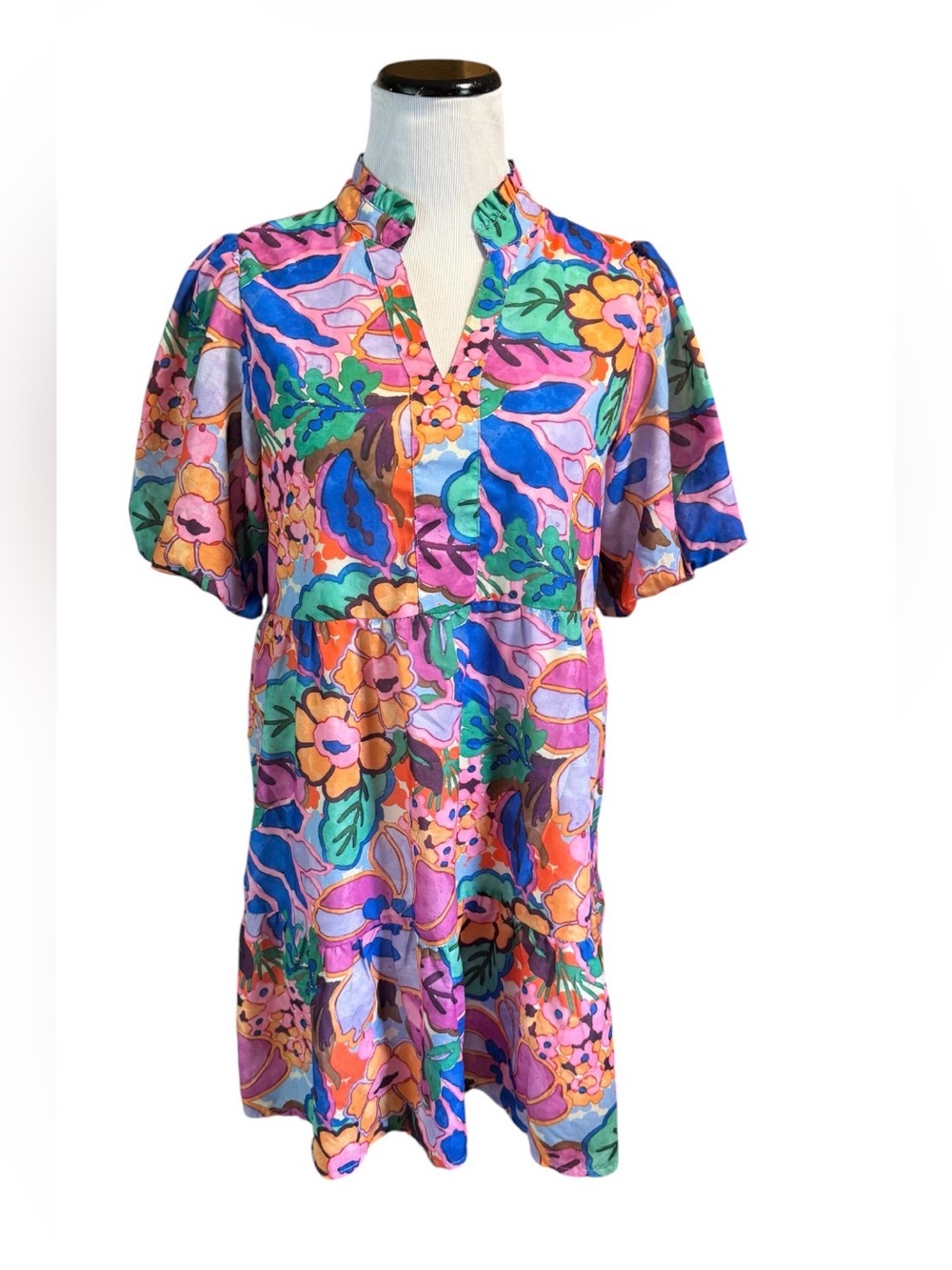 THML floral tiered mini dress featuring a notched V-neck and short puff sleeves.